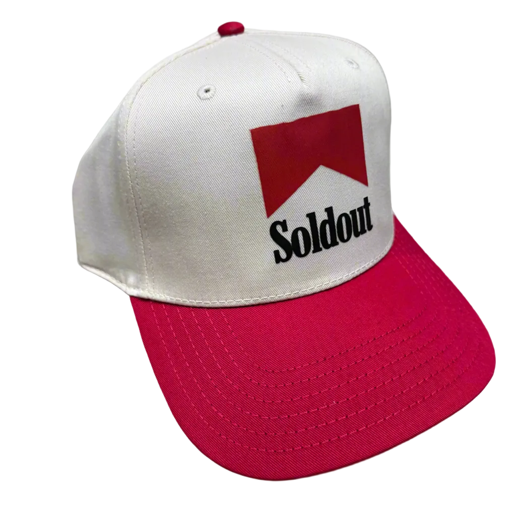 Cream snapback hat with red brim and embroidered red Sold Out cigarette-style logo on front