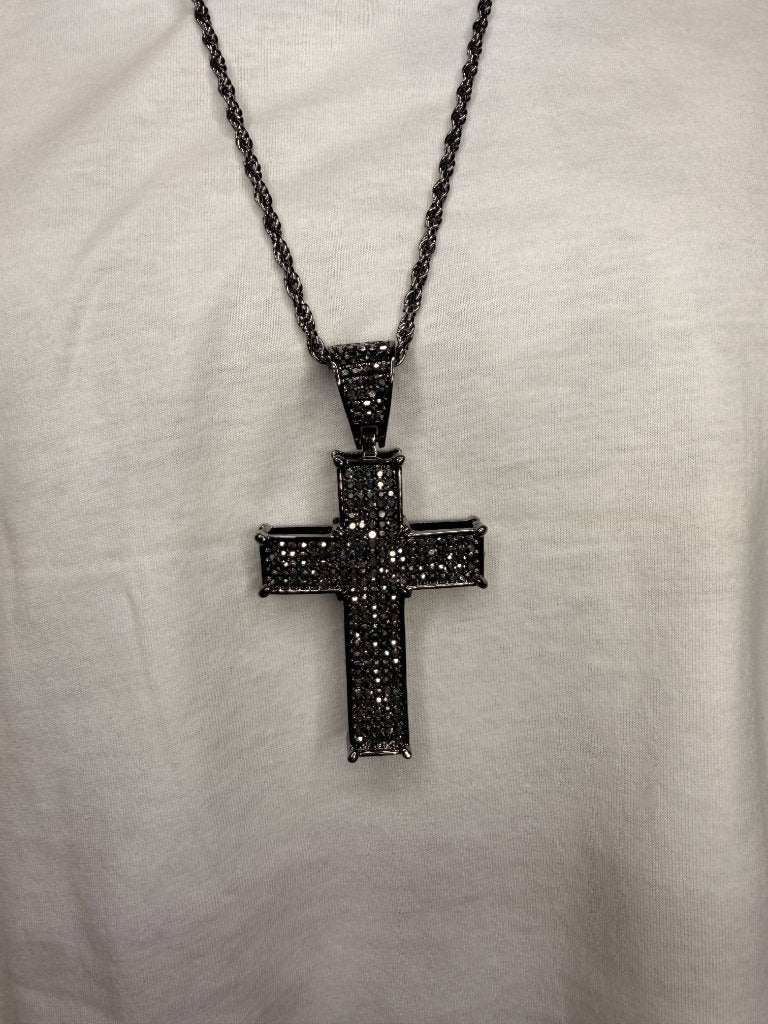 Black ornate cross pendant necklace close up detail black stones