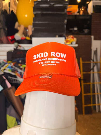 Skid Row Parks and Recreation orange trucker hat front white text LA