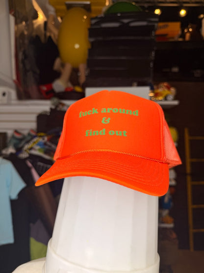 Fuck around and find out orange trucker hat front green text