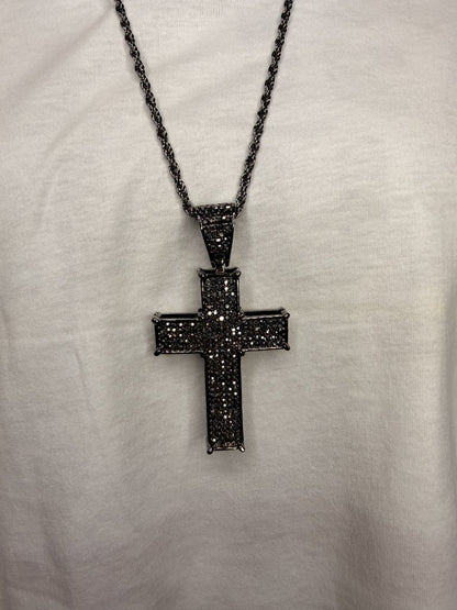 Black ornate cross pendant necklace close up detail black stones